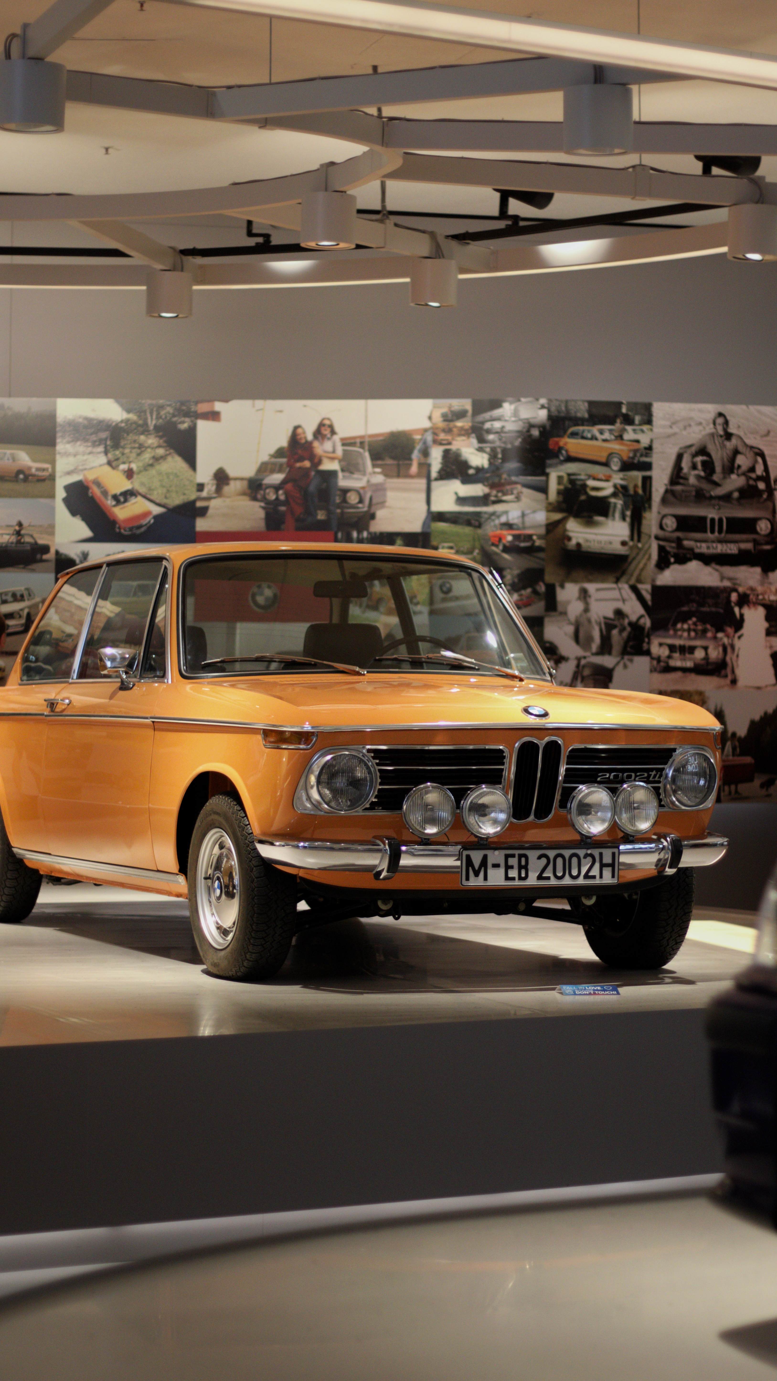 A classic yellow BMW on display